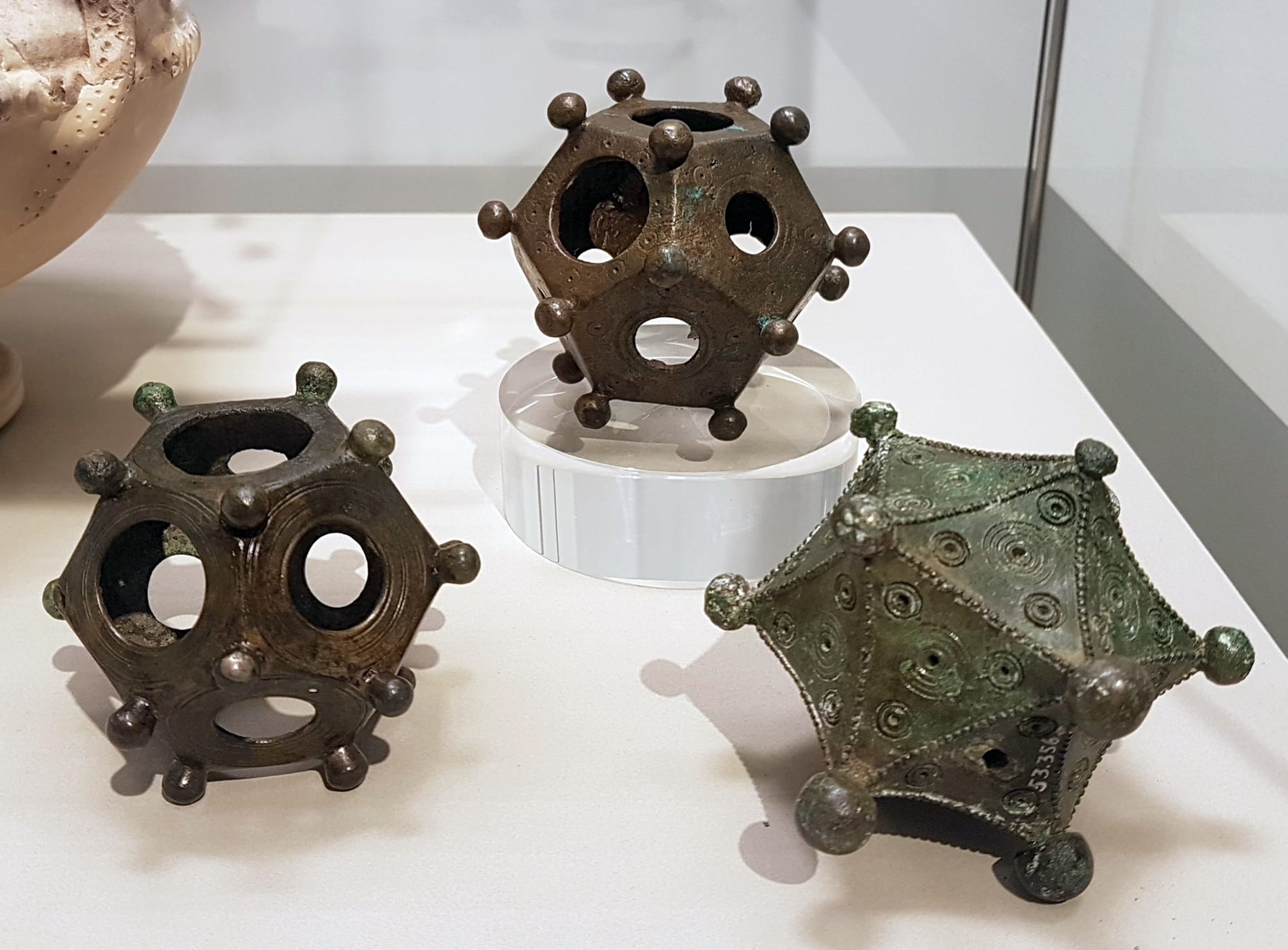 Two ancient Roman bronze dodecahedrons and an icosahedron