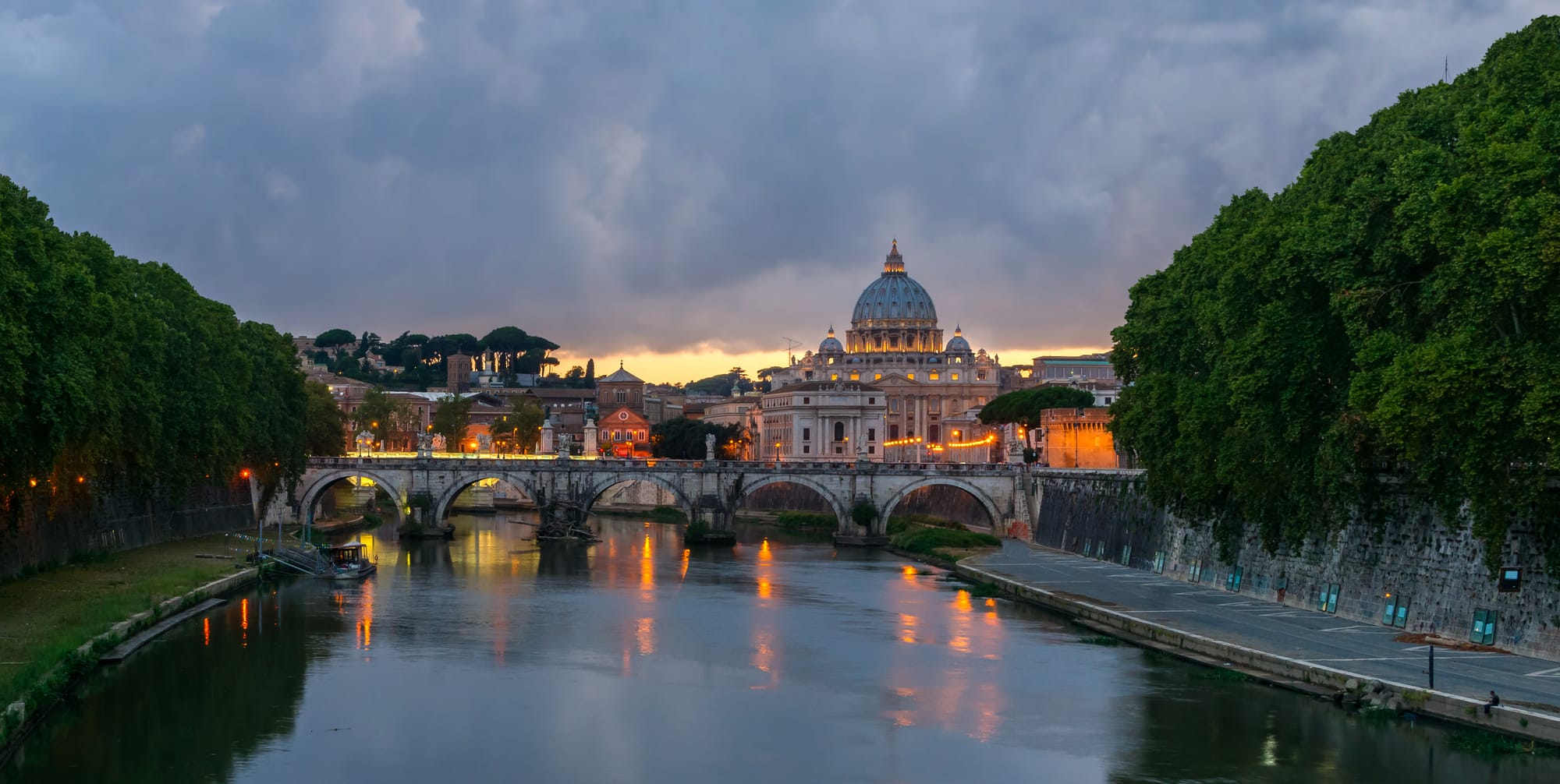 Sant'Angelo bridge (Ponte Sant'Angelo), Saint Peter's Basilica, at dusk, from Umberto I bridge, Rome, Italy.