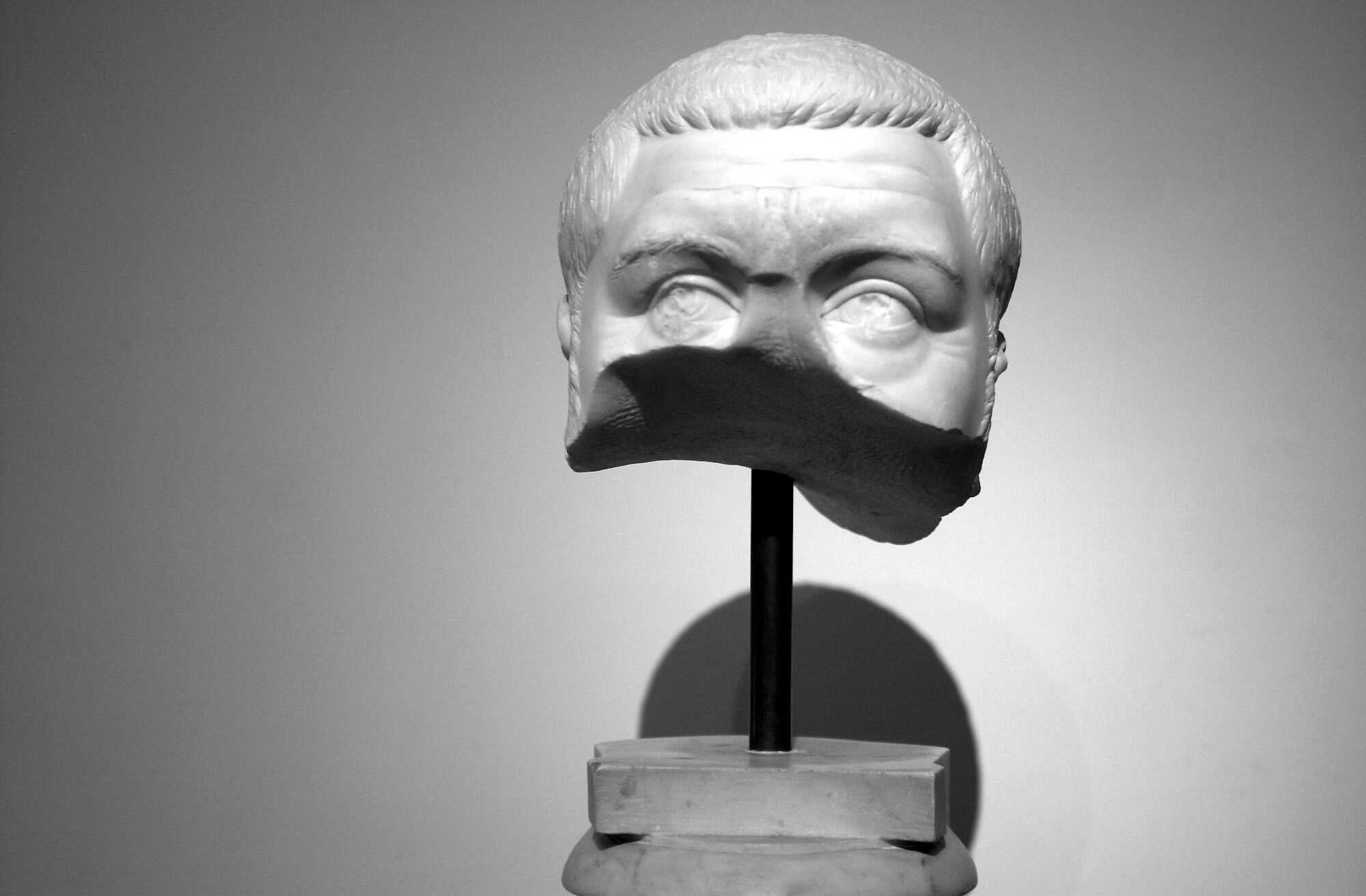 A broken bust of Maximinus Thrax, found in the Antiquario del Palatino, poetically illustrating the divided opinion of his subjects about him. 