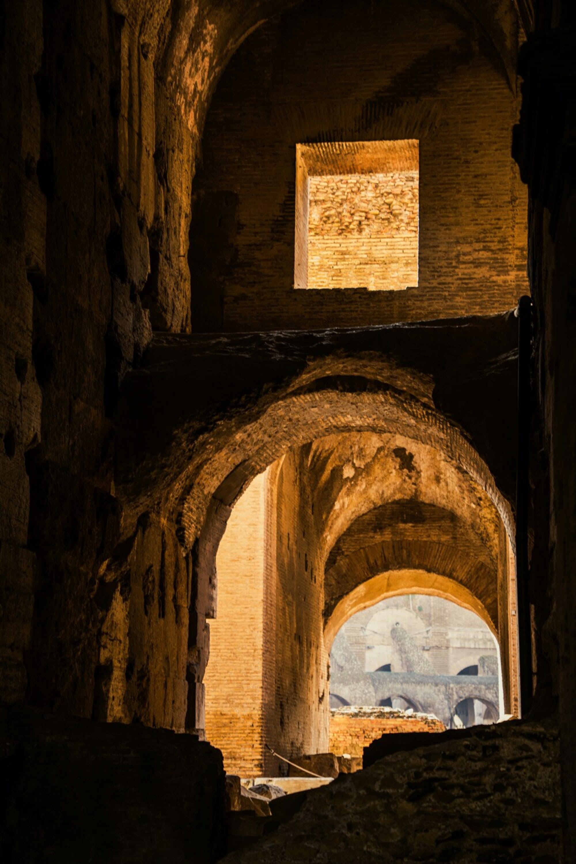 Arches and pillars inside the ruin of the ancient Colosseum at Rome.