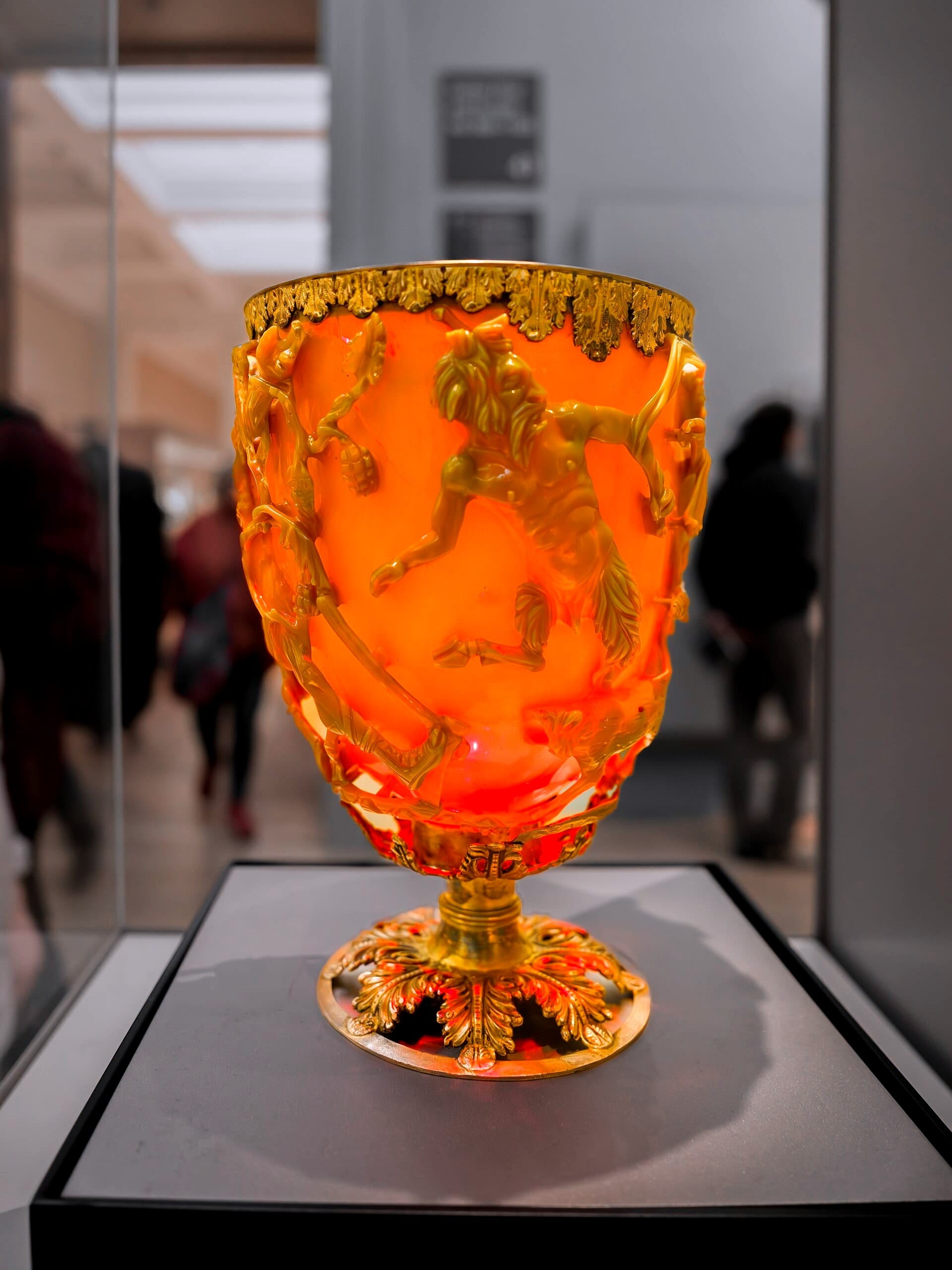 Drinking-cup; glass; green and red; covered with various scenes representing the death of King Lycurgus; rim mounted with silver-gilt band of leaf ornament, plus silver-gilt foot with open-work vine leaves.